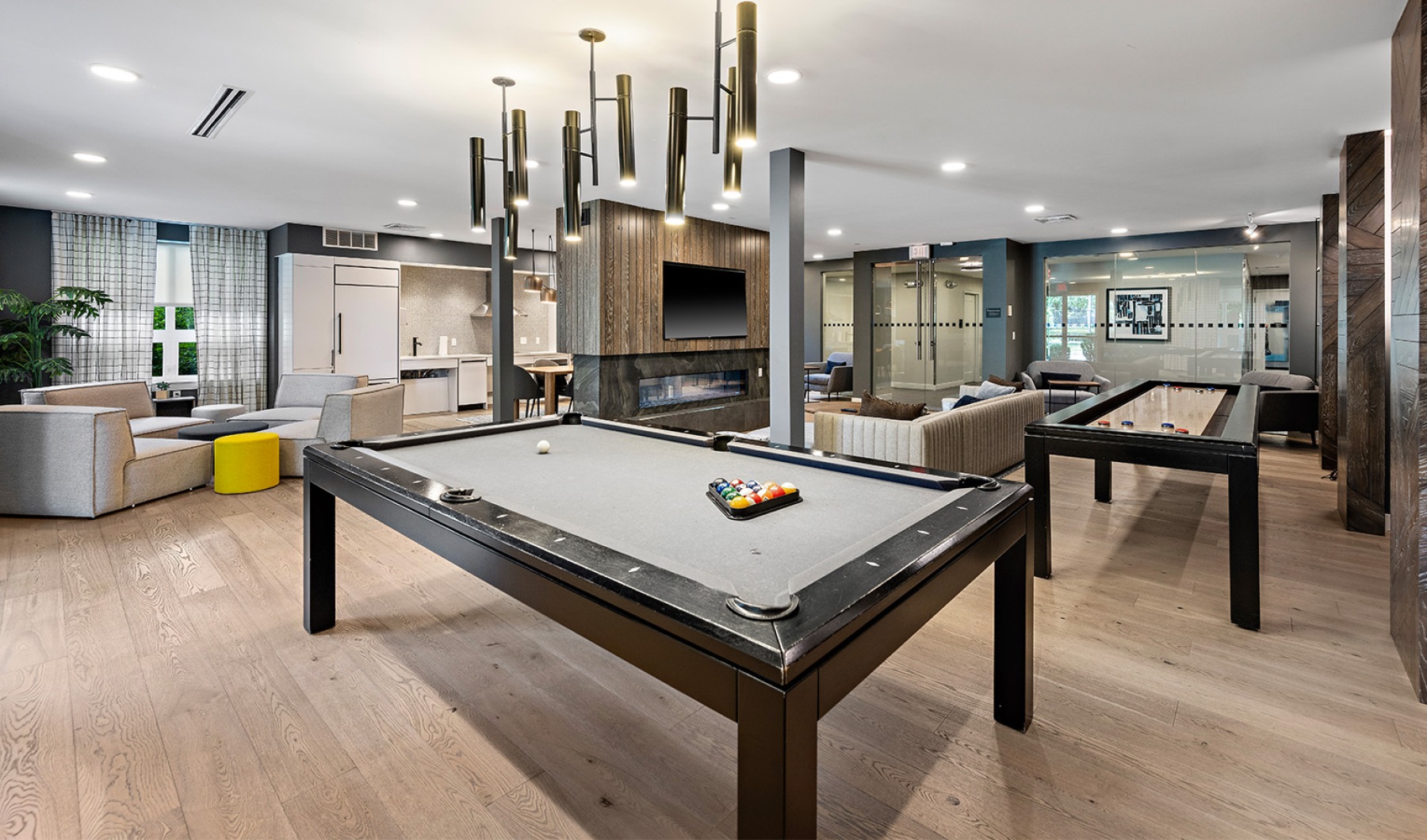 Clubhouse a room with a pool table and shuffleboard